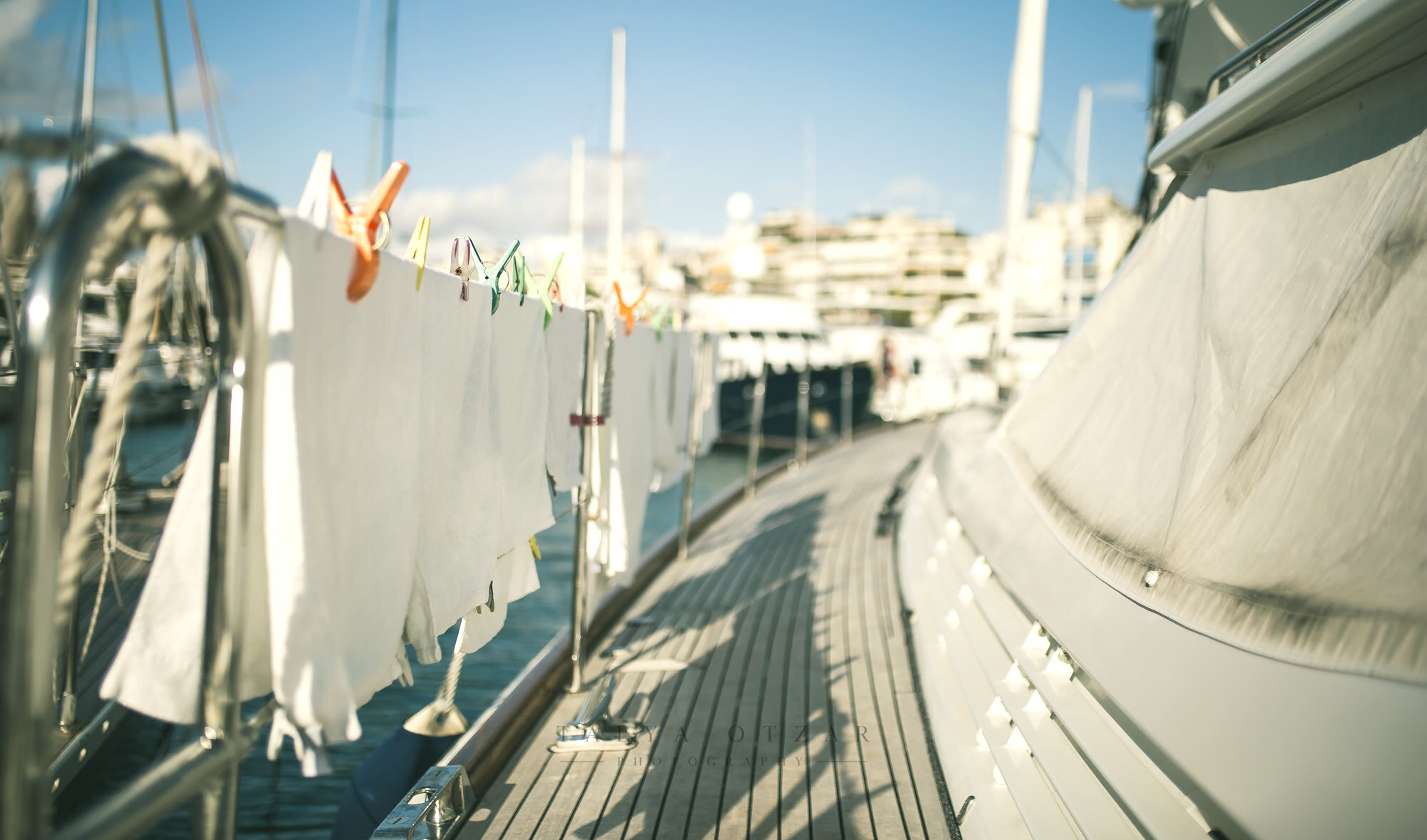 Washing pegged along the rail of a yacht drying in the sun