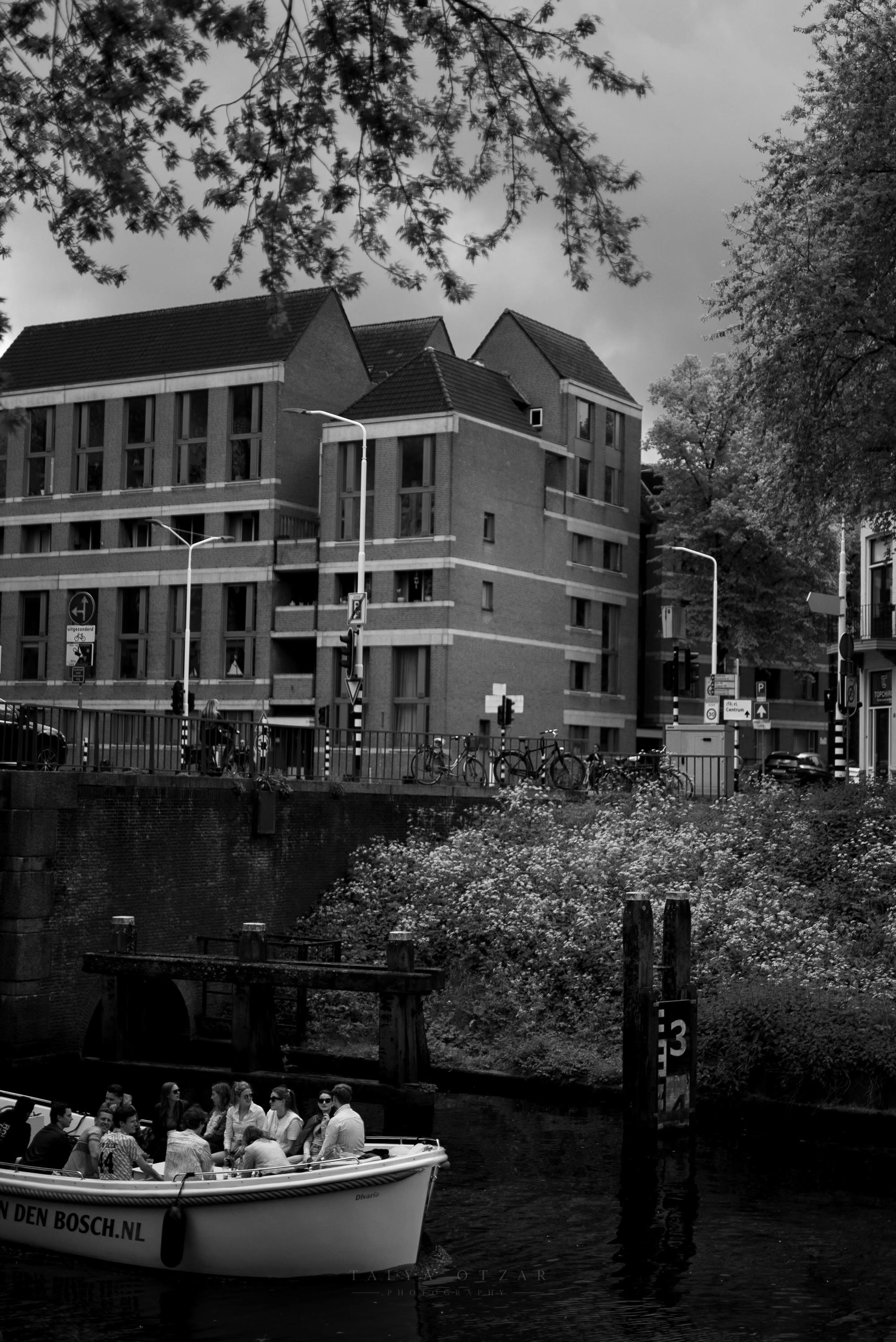 The canal tour boat setting off below the town's brick façades
