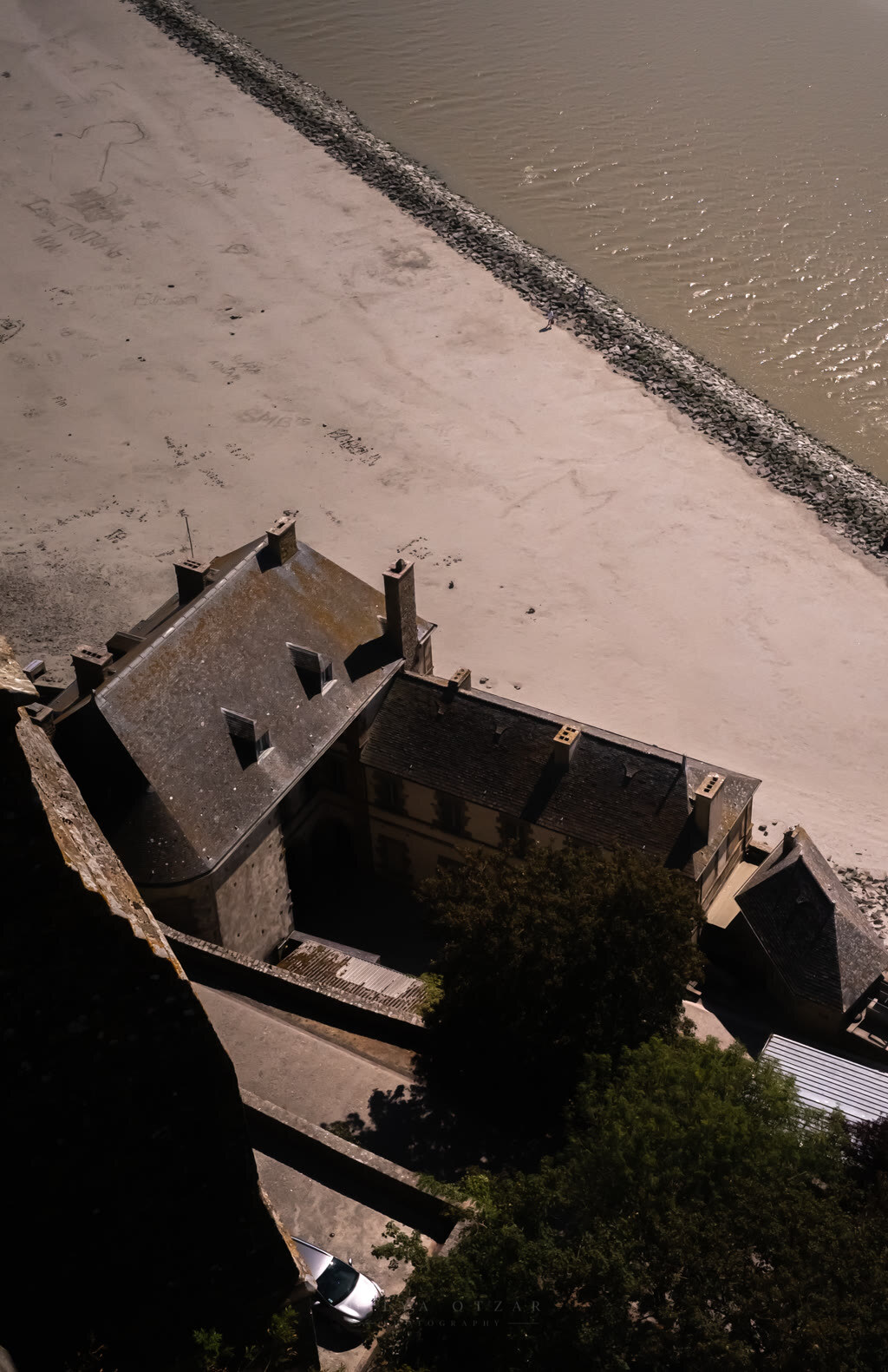 Looking down from the abbey walls onto the rooftops and the tidal sands