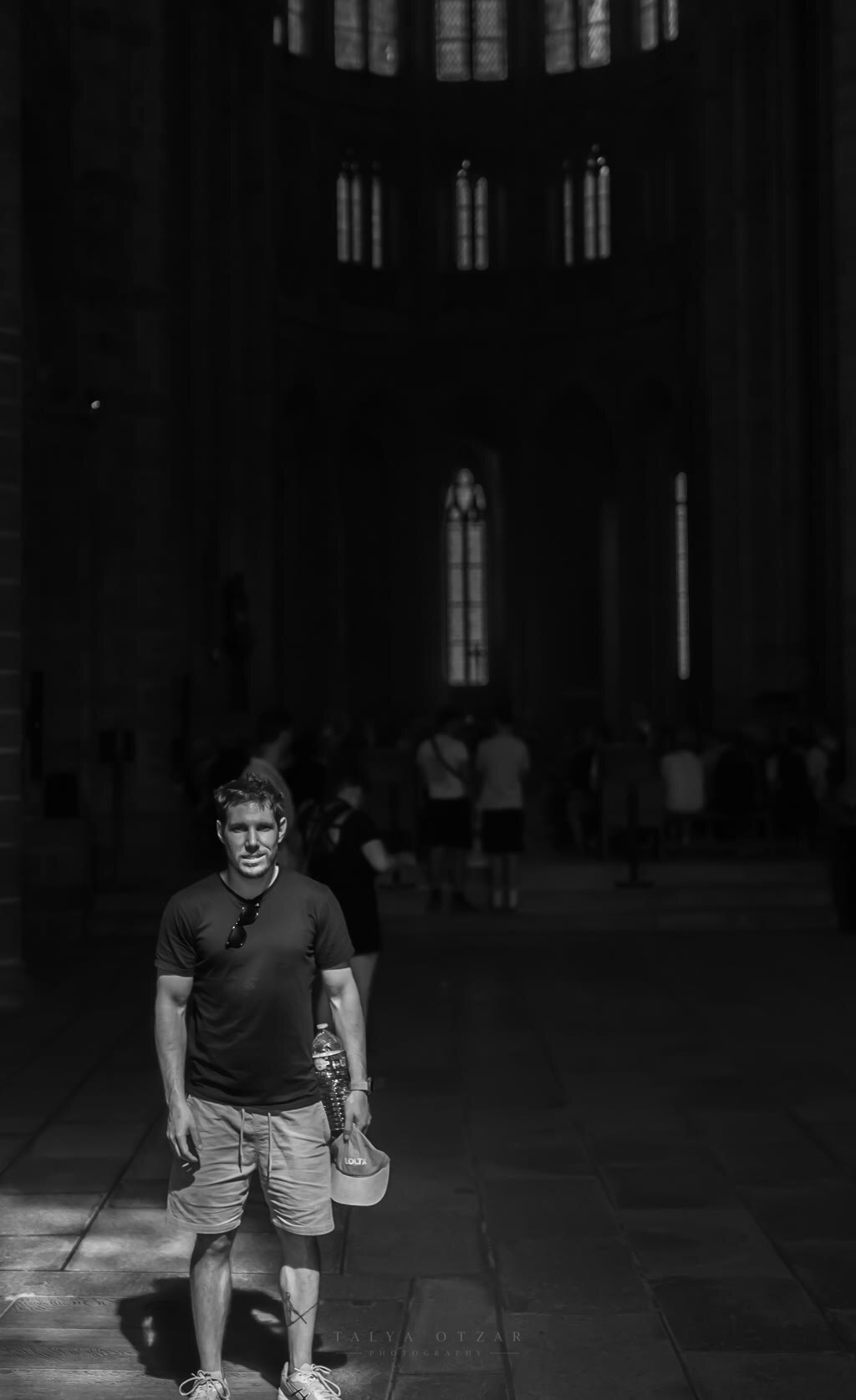 A man standing in a shaft of light in the vast nave of a cathedral