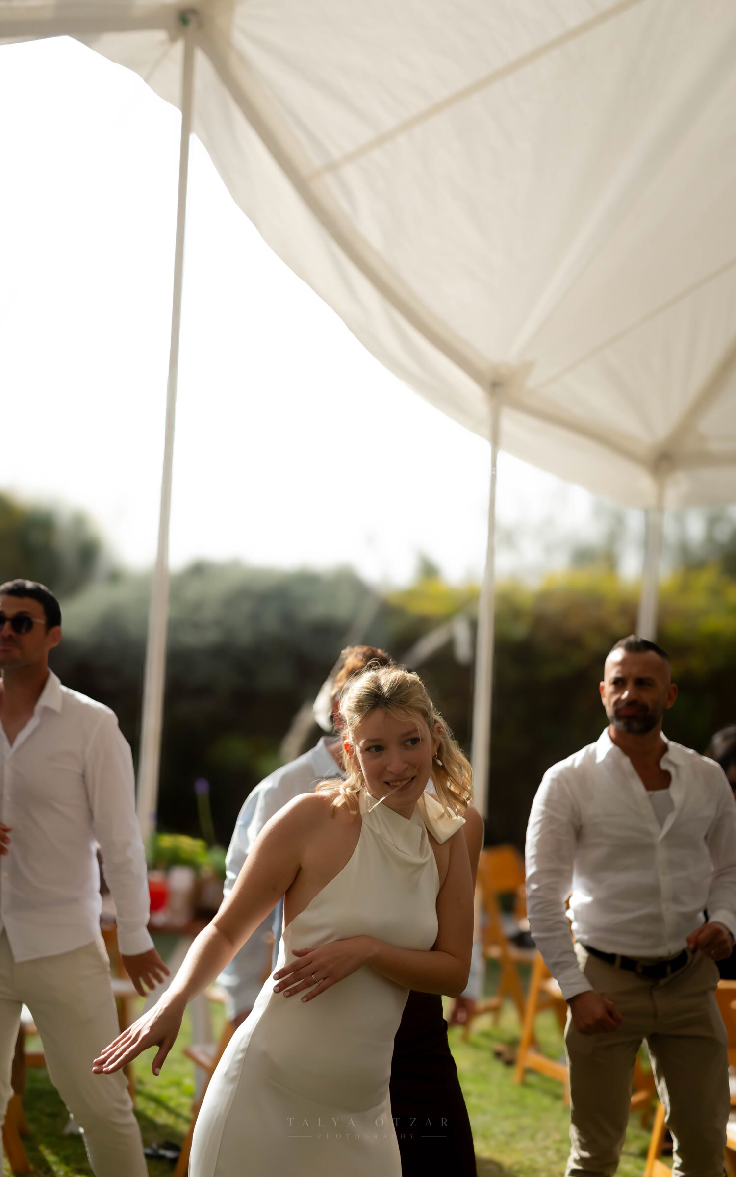 The bride dancing under the marquee, her hair loose