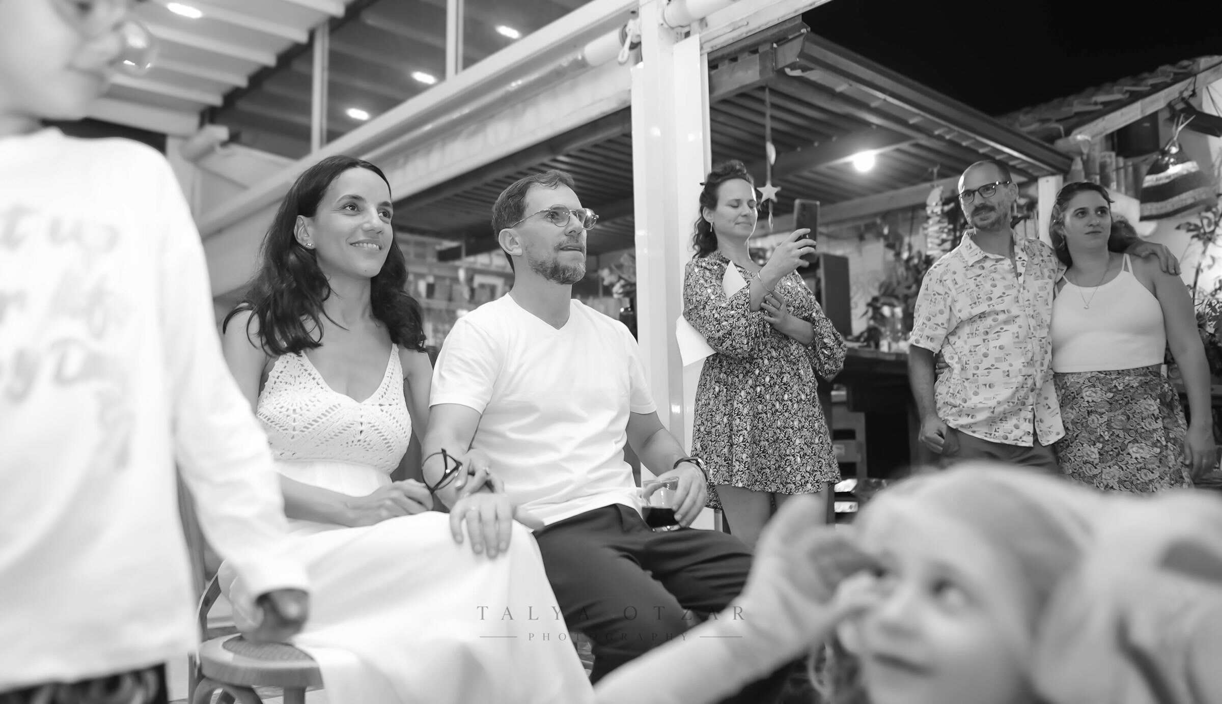 Guests watching from their seats, children moving through the foreground