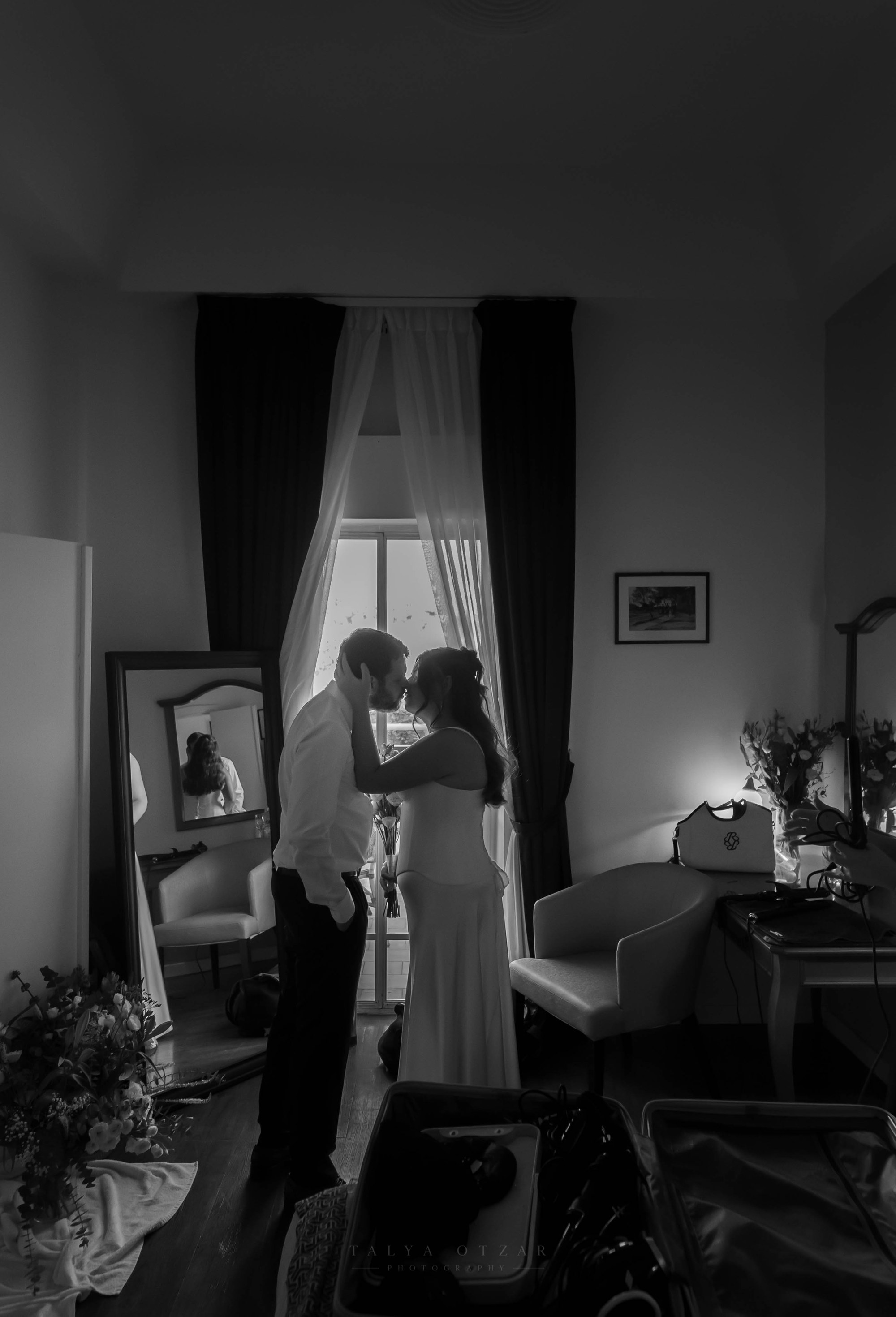 The couple embracing beside the tall window, black and white
