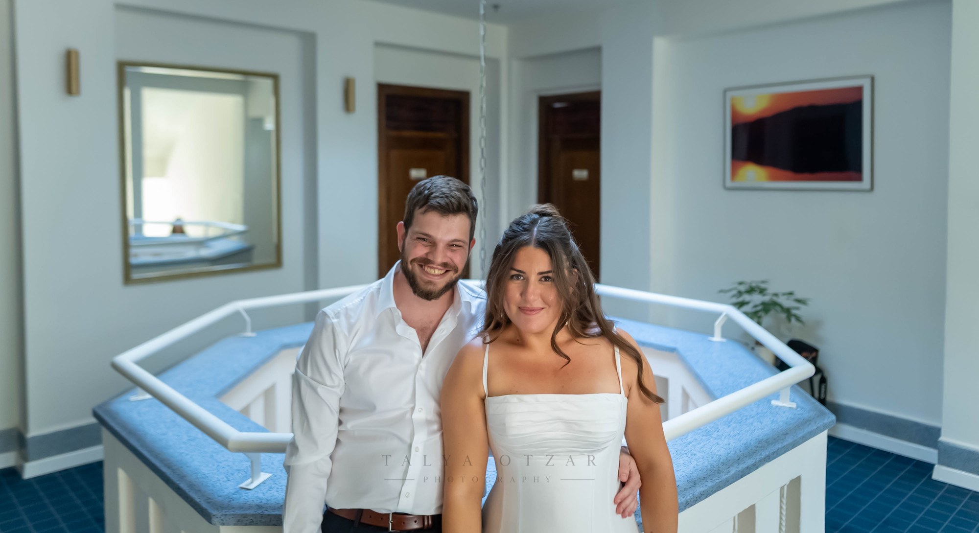 The couple standing together in the stairwell lobby