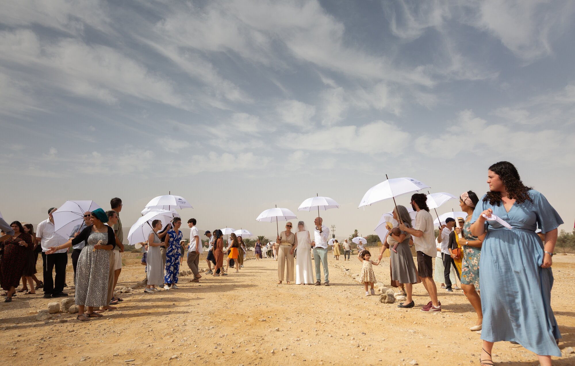 Guests lining the desert path as the procession passes