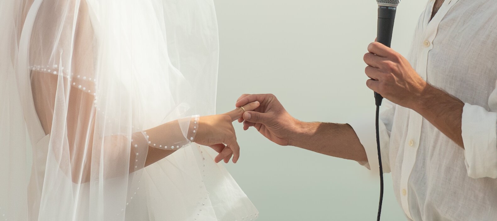 The groom placing the ring on the bride's finger