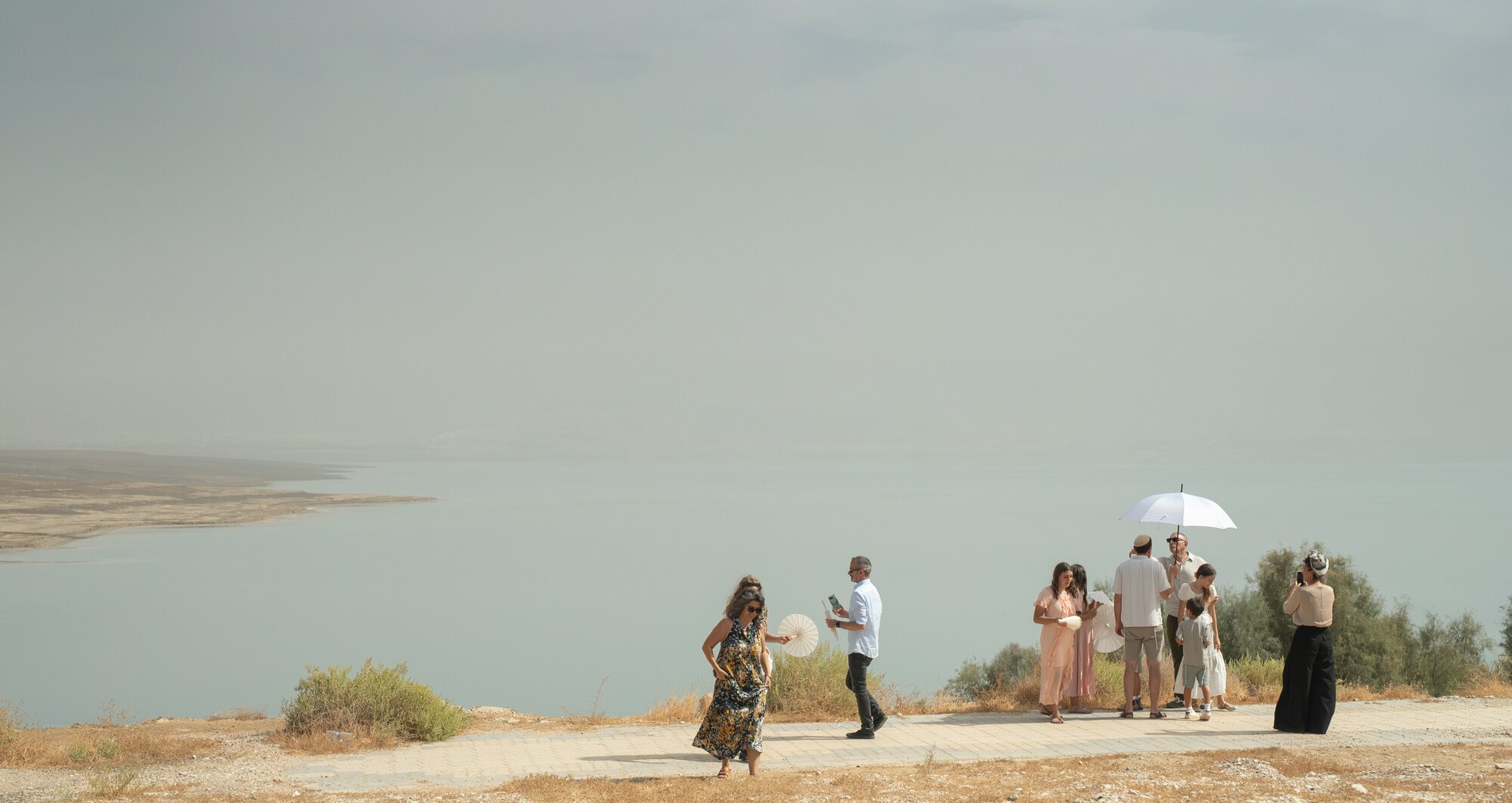 Guests gathering on the clifftop above the Dead Sea after the ceremony