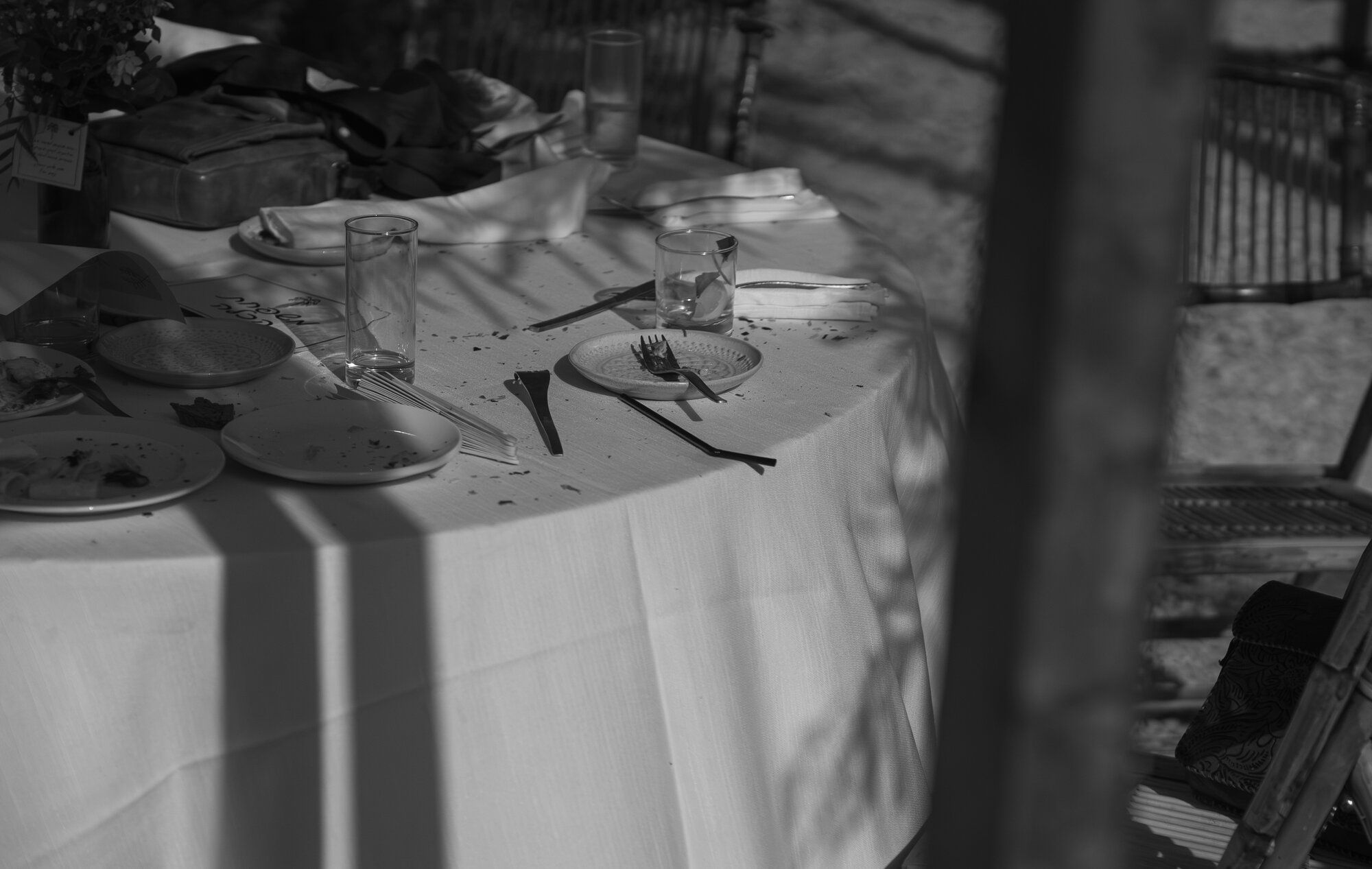 A cleared table after the meal, black and white